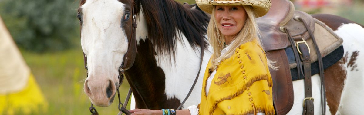 Madeline Pickens spends her life saving America's Mustangs. Here with her horse "Paint".