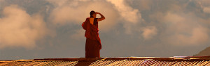 A monk on a rooftop in the Himalayans. Copyright: Marco Roth